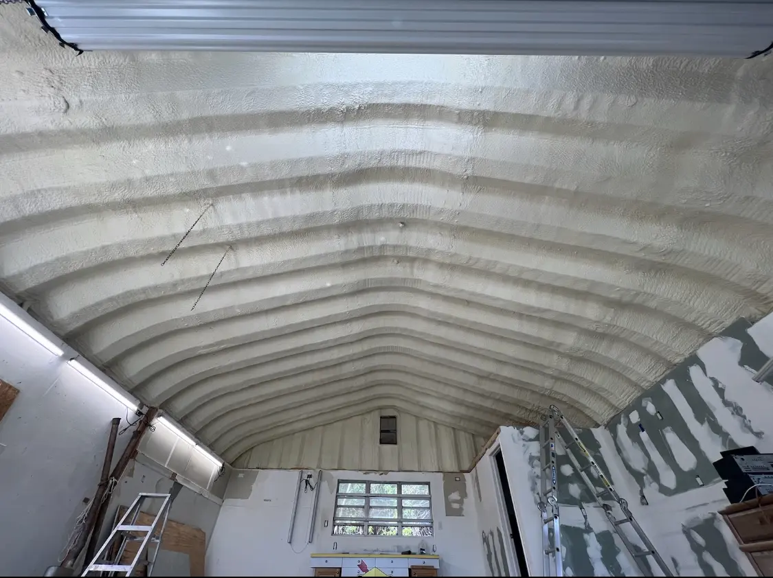 Spray polyurethane foam applied to the underside of a metal roof deck in Sandy